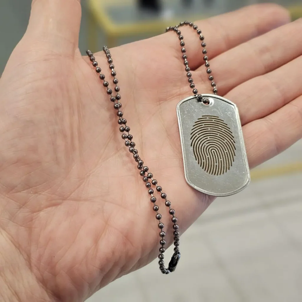 Fingerprint laser engraving on silver pendant